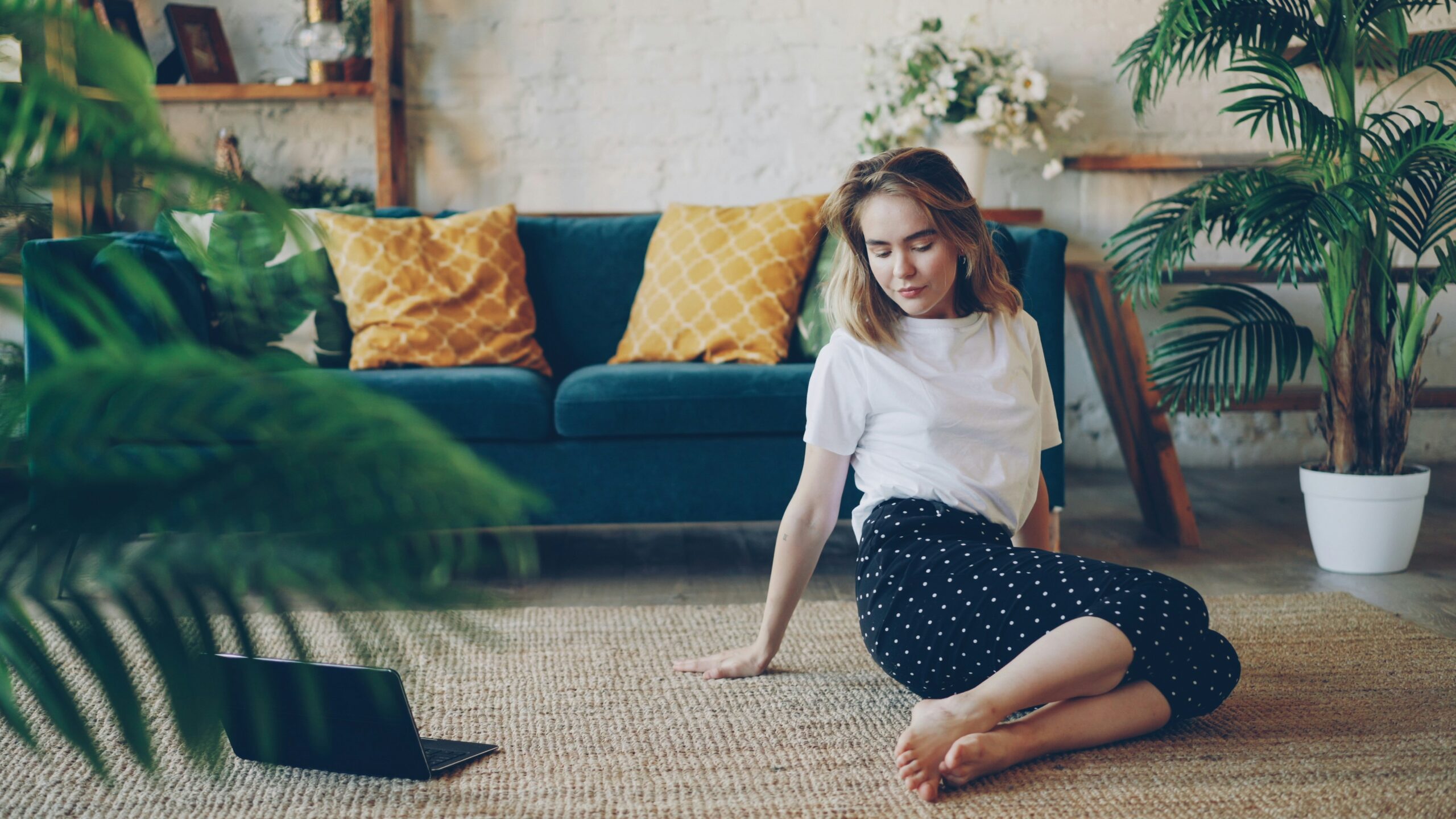Why Every Woman Needs a Freedom Fund Woman practising morning yoga at home in soft sunlight, representing financial freedom and a life lived on your own terms